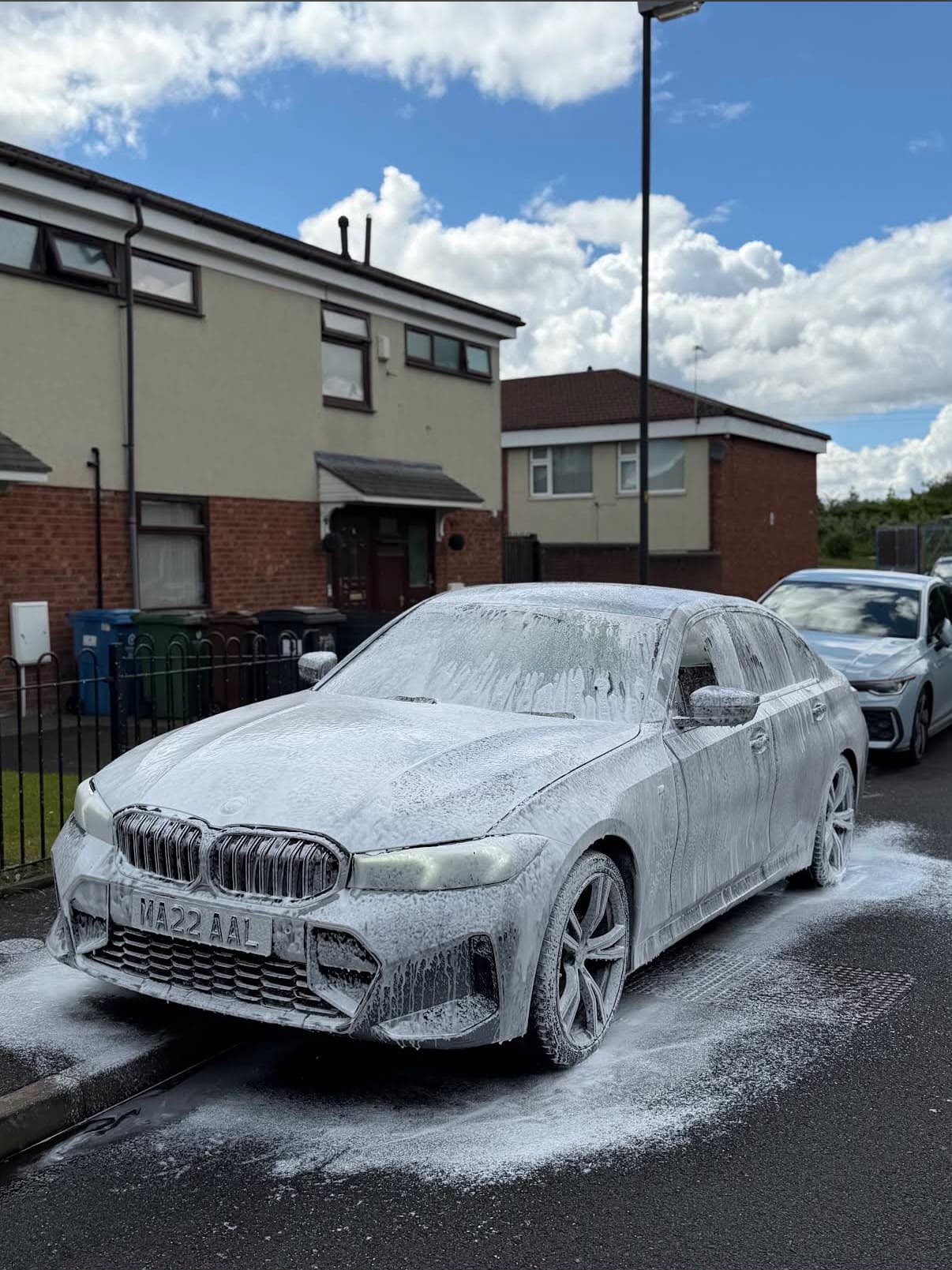 BMW 3 Series covered in snow foam during a mobile wash