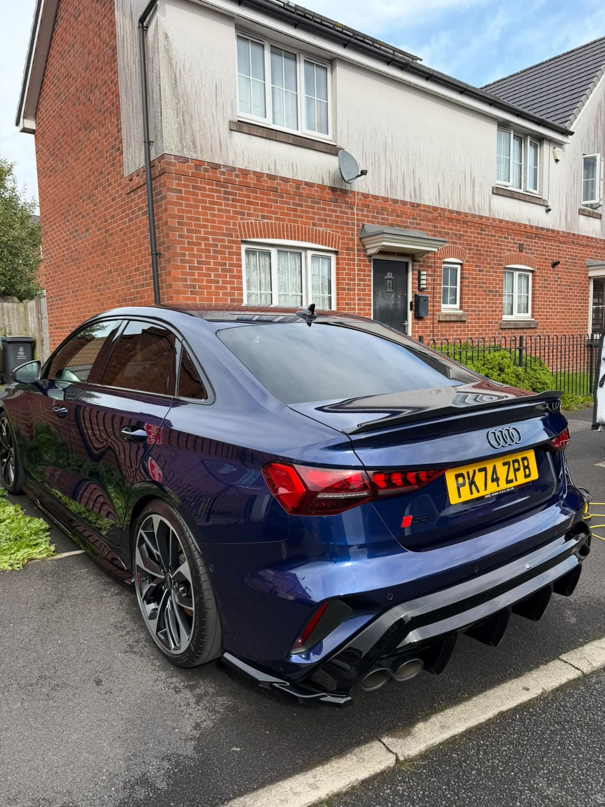A deep blue Audi S3 with a polished, glossy finish